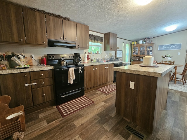 421 Dry Branch Rd, Morehead, KY 40351 - kitchen with black appliances, under cabinet range hood, dark wood-style flooring, light countertops, and a textured ceiling