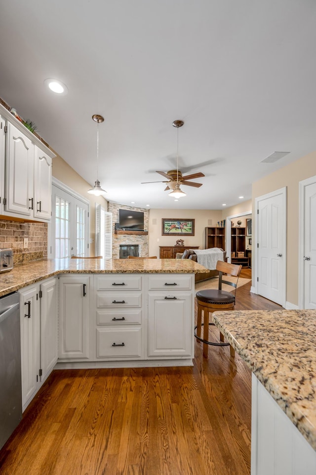 2609 Idlewood Dr, Lexington, KY 40513 - kitchen featuring stainless steel dishwasher, a ceiling fan, white cabinets, open floor plan, and a peninsula