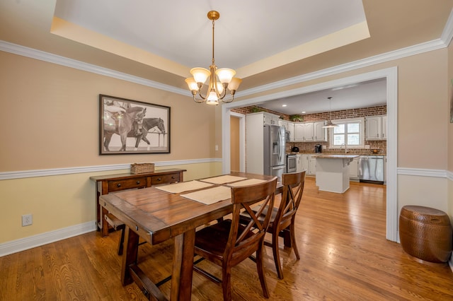 2609 Idlewood Dr, Lexington, KY 40513 - dining area with a chandelier, wood finished floors, and a tray ceiling