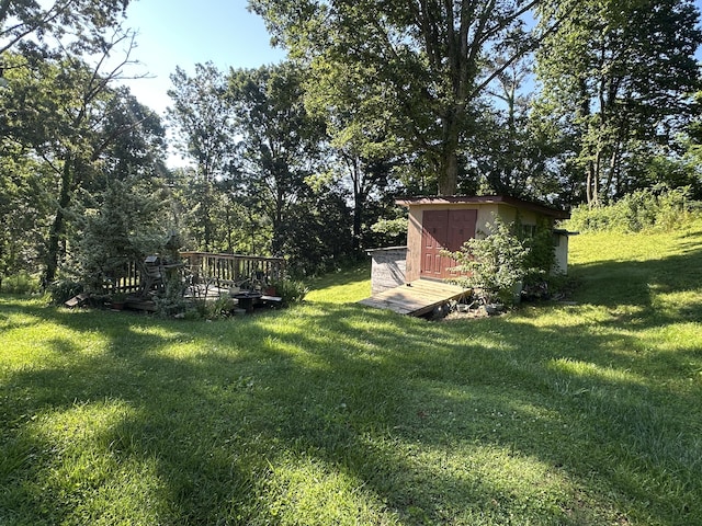 21 Herb Neal Rd, Pine Knot, KY 42635 - view of grassy yard featuring a storage unit and a deck