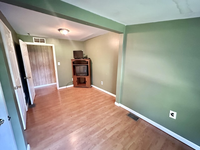 21 Herb Neal Rd, Pine Knot, KY 42635 - unfurnished living room featuring wood finished floors and baseboards