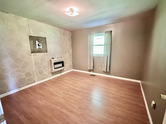 21 Herb Neal Rd, Pine Knot, KY 42635 - unfurnished living room with heating unit, wood finished floors, and a textured ceiling