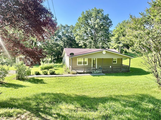 21 Herb Neal Rd, Pine Knot, KY 42635 - view of front of house with a porch, a front yard, and a metal roof