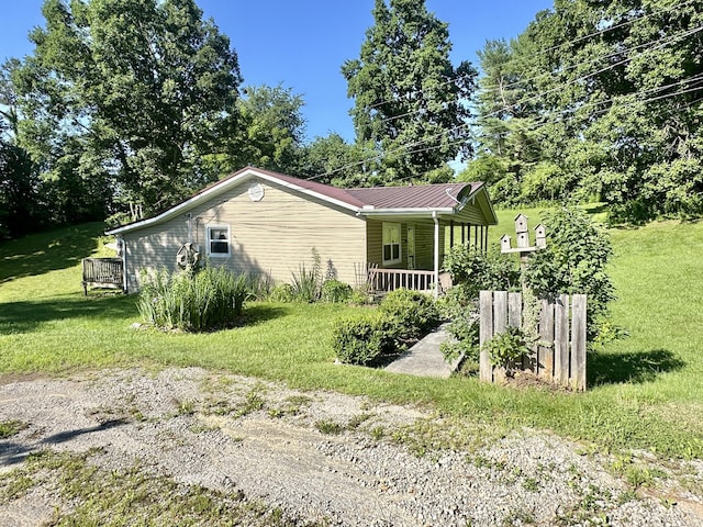 21 Herb Neal Rd, Pine Knot, KY 42635 - view of side of home featuring covered porch, a lawn, and a metal roof