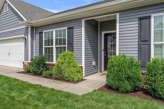 117 Mcafee Dr, Nicholasville, KY 40356 - view of exterior entry featuring a garage and a shingled roof