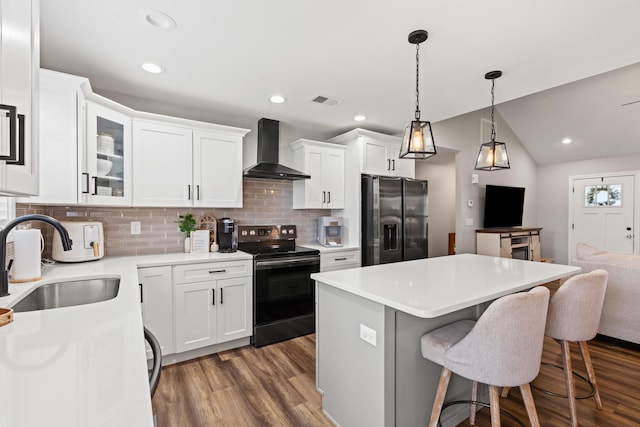 309 Memory Ln, Richmond, KY 40475 - kitchen with black electric range, refrigerator with ice dispenser, wall chimney exhaust hood, a kitchen bar, and a center island