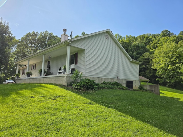 1445 Bastin Creek Rd, Kings Mountain, KY 40442 - view of home's exterior with a lawn, a chimney, and covered porch