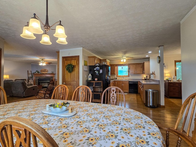 1445 Bastin Creek Rd, Kings Mountain, KY 40442 - dining space featuring a ceiling fan, a fireplace, wood finished floors, a chandelier, and a textured ceiling