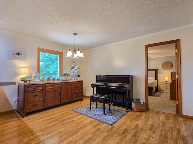1445 Bastin Creek Rd, Kings Mountain, KY 40442 - sitting room with light wood-style floors, a textured ceiling, a chandelier, and crown molding