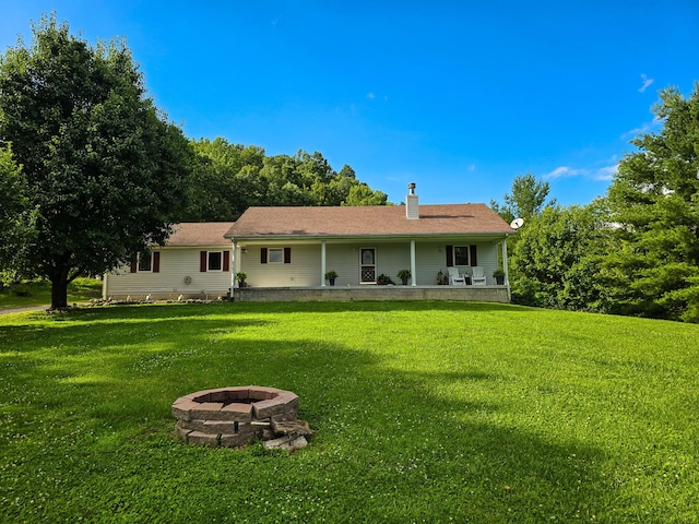 1445 Bastin Creek Rd, Kings Mountain, KY 40442 - rear view of house with an outdoor fire pit, a lawn, and a chimney