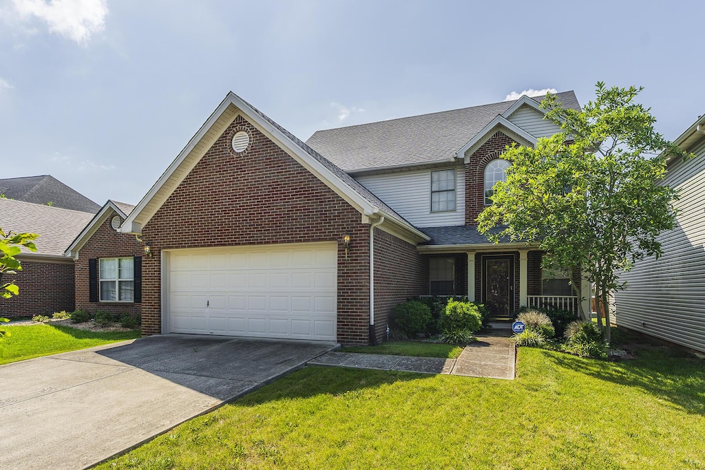 649 Vonbryan Trce, Lexington, KY 40509 - traditional home featuring a garage, brick siding, concrete driveway, and a front lawn