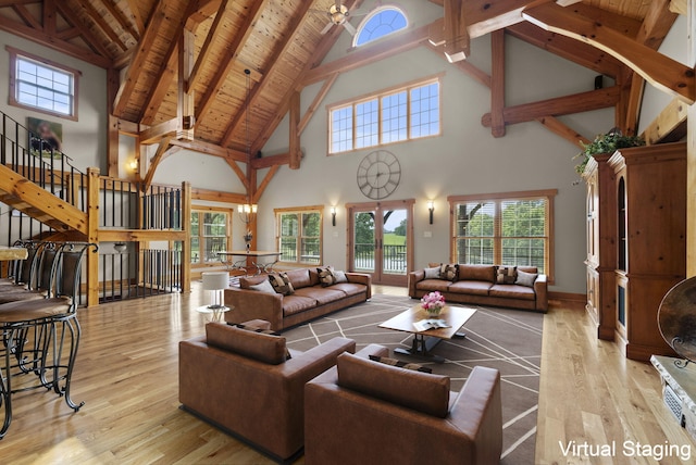 4111 Stanford Rd, Danville, KY 40422 - living area with high vaulted ceiling, wood finished floors, plenty of natural light, stairway, and a wooden ceiling with exposed beams