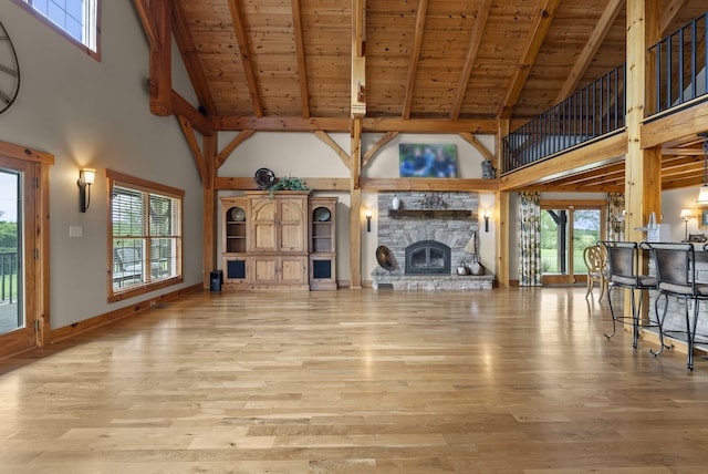 4111 Stanford Rd, Danville, KY 40422 - unfurnished living room featuring high vaulted ceiling, a wood ceiling with exposed beams, wood finished floors, healthy amount of natural light, and a fireplace