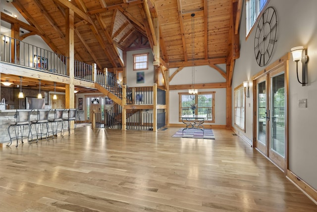 4111 Stanford Rd, Danville, KY 40422 - unfurnished living room featuring high vaulted ceiling, a wood ceiling with exposed beams, wood finished floors, stairway, and a chandelier