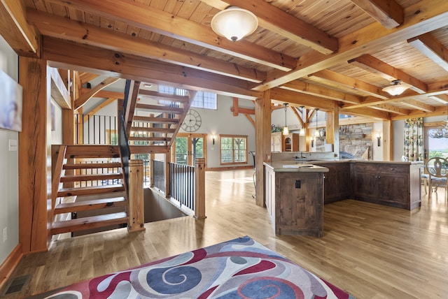 4111 Stanford Rd, Danville, KY 40422 - kitchen featuring light wood-style flooring, a wooden ceiling with exposed beams, a peninsula, dark brown cabinets, and stainless steel counters