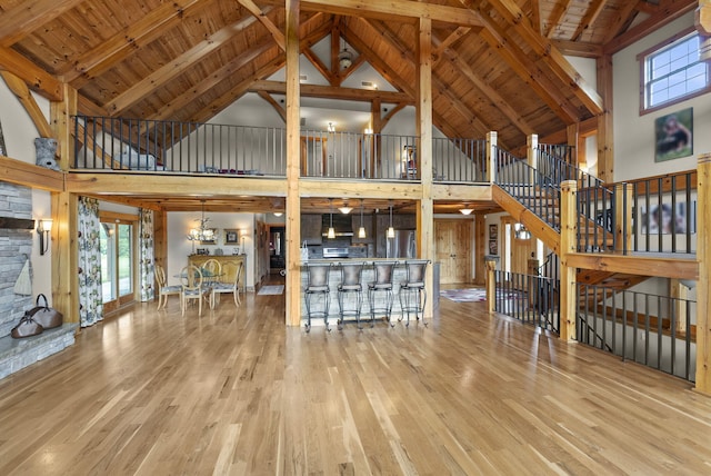 4111 Stanford Rd, Danville, KY 40422 - unfurnished living room featuring high vaulted ceiling, wood finished floors, a chandelier, and a wood ceiling with exposed beams