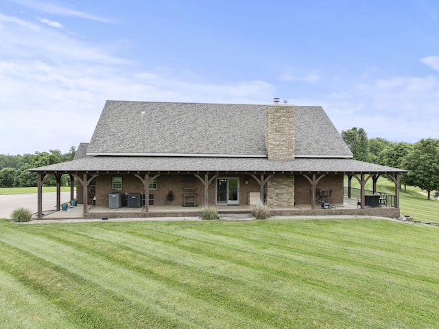 4111 Stanford Rd, Danville, KY 40422 - back of house featuring a lawn, a chimney, a shingled roof, and brick siding