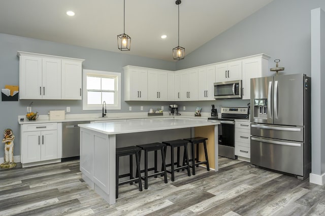 2562 High Bridge Rd, Lancaster, KY 40444 - kitchen featuring stainless steel appliances, a center island, white cabinets, a breakfast bar area, and light countertops
