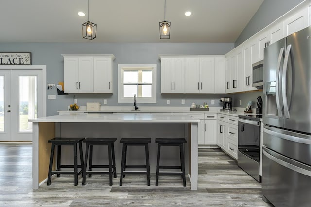 2562 High Bridge Rd, Lancaster, KY 40444 - kitchen with appliances with stainless steel finishes, light countertops, a kitchen breakfast bar, lofted ceiling, and recessed lighting
