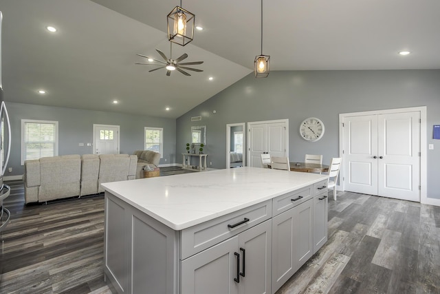 2562 High Bridge Rd, Lancaster, KY 40444 - kitchen featuring a kitchen island, a ceiling fan, dark wood-style flooring, high vaulted ceiling, and decorative light fixtures