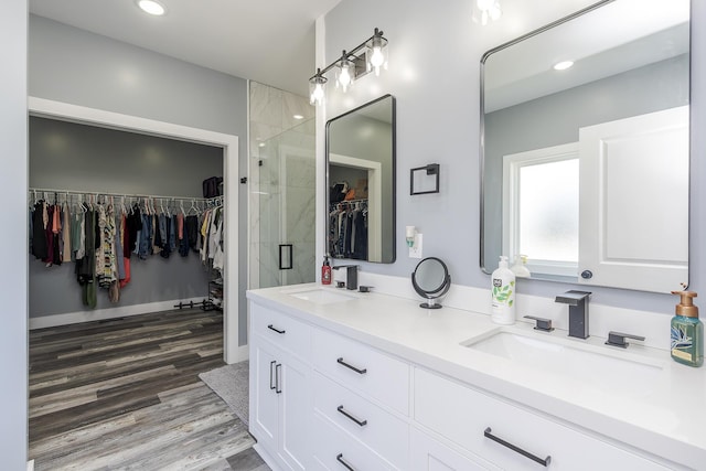 2562 High Bridge Rd, Lancaster, KY 40444 - full bath with double vanity, wood finished floors, a walk in closet, a stall shower, and recessed lighting