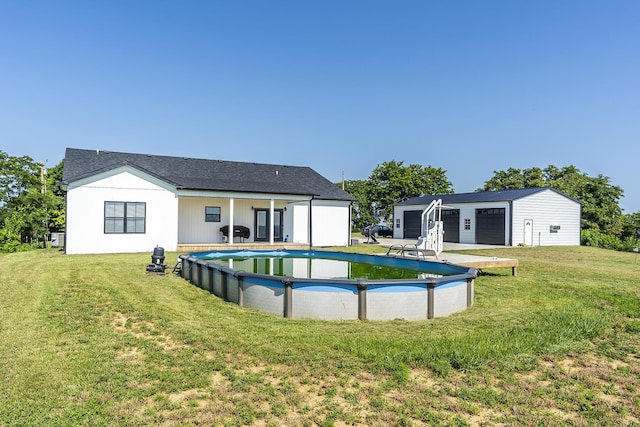 2562 High Bridge Rd, Lancaster, KY 40444 - rear view of house with an outdoor structure, an outdoor pool, a garage, and a yard