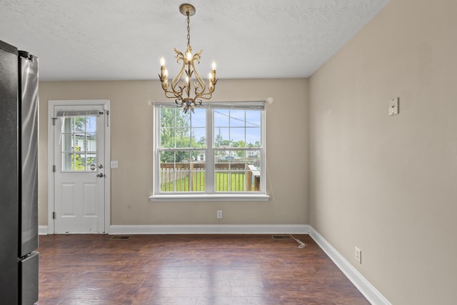 263 Hunter Ridge Dr, Lawrenceburg, KY 40342 - unfurnished dining area featuring a chandelier, dark wood-style flooring, and a textured ceiling