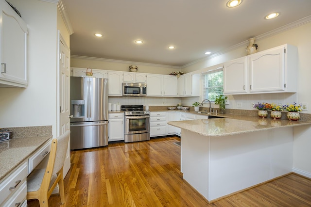 4129 Amberwood Ct, Lexington, KY 40513 - kitchen featuring stainless steel appliances, a peninsula, crown molding, light stone counters, and white cabinets