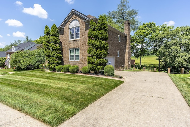 4129 Amberwood Ct, Lexington, KY 40513 - view of property exterior featuring concrete driveway, a lawn, brick siding, and a chimney