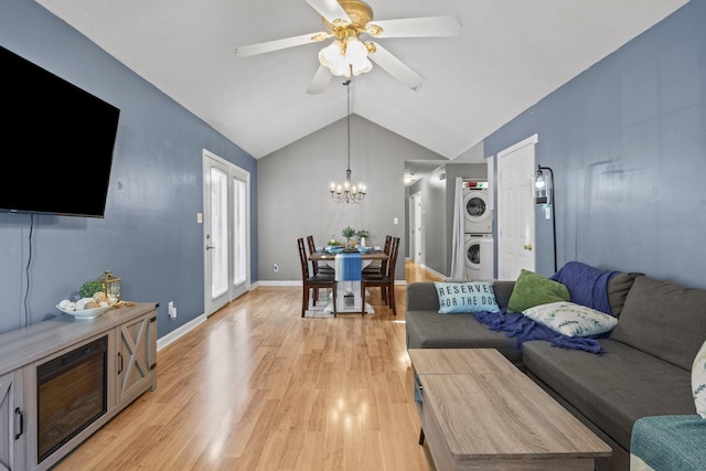 1008 Marshall Park Dr, Georgetown, KY 40324 - living room featuring stacked washer / dryer, light wood finished floors, lofted ceiling, ceiling fan, and a chandelier
