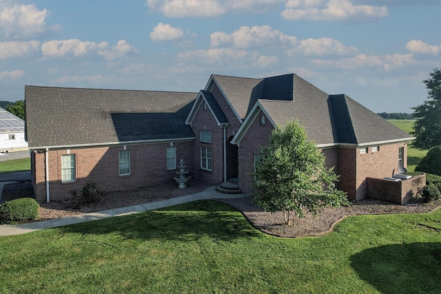 168 Master Ct, Hustonville, KY 40437 - view of front of home with brick siding, a front lawn, and a shingled roof