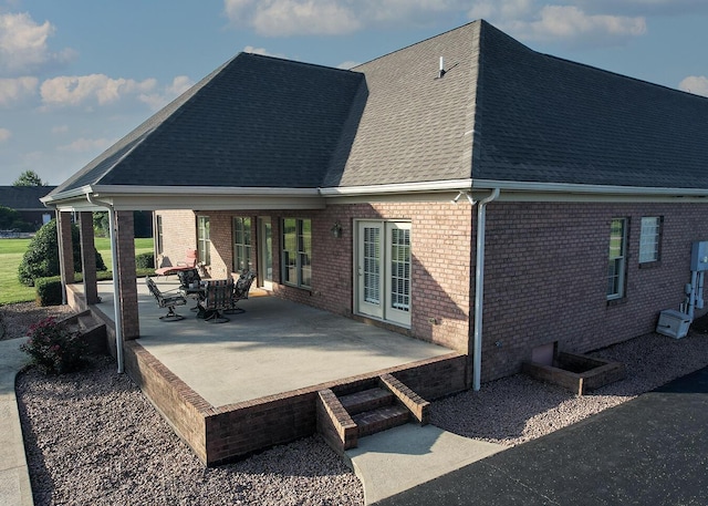 168 Master Ct, Hustonville, KY 40437 - back of house featuring roof with shingles, brick siding, and a patio