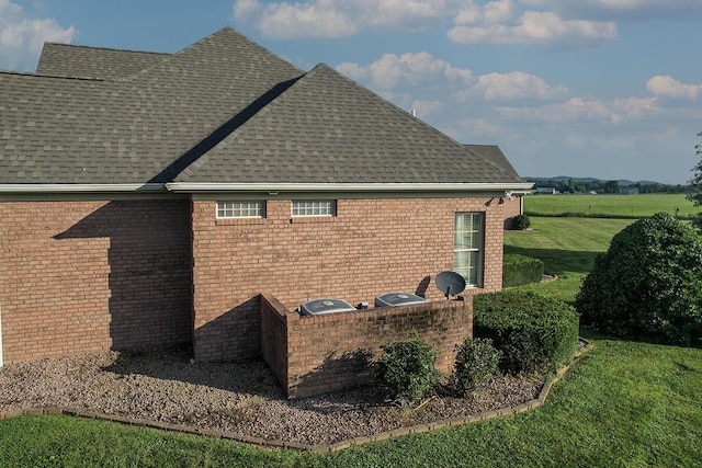 168 Master Ct, Hustonville, KY 40437 - view of side of property with roof with shingles, brick siding, and a yard
