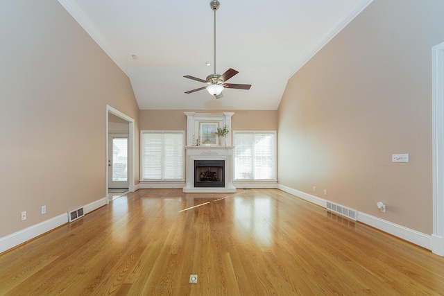 168 Master Ct, Hustonville, KY 40437 - unfurnished living room featuring ceiling fan, lofted ceiling, light wood-type flooring, a fireplace with raised hearth, and crown molding