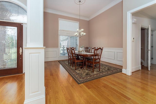 168 Master Ct, Hustonville, KY 40437 - dining space featuring light wood finished floors, a chandelier, crown molding, wainscoting, and a decorative wall