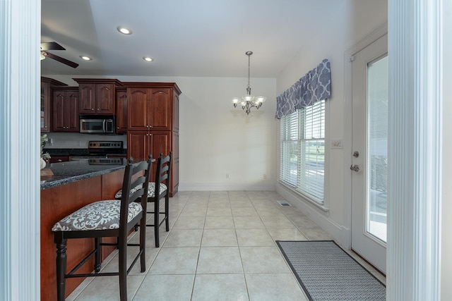 168 Master Ct, Hustonville, KY 40437 - kitchen with stainless steel appliances, a kitchen bar, a ceiling fan, a chandelier, and pendant lighting