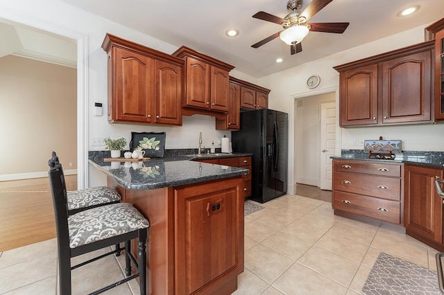 168 Master Ct, Hustonville, KY 40437 - kitchen with black refrigerator with ice dispenser, a kitchen breakfast bar, ceiling fan, dark stone counters, and recessed lighting