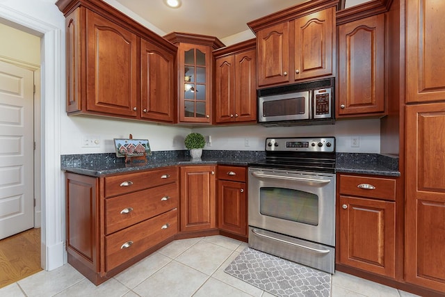 168 Master Ct, Hustonville, KY 40437 - kitchen featuring appliances with stainless steel finishes, glass insert cabinets, dark stone countertops, and brown cabinetry