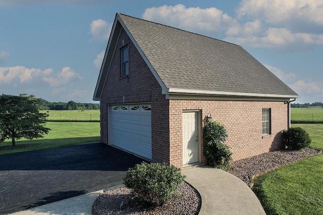 168 Master Ct, Hustonville, KY 40437 - view of property exterior featuring a lawn, a shingled roof, brick siding, a view of rural / pastoral area, and driveway