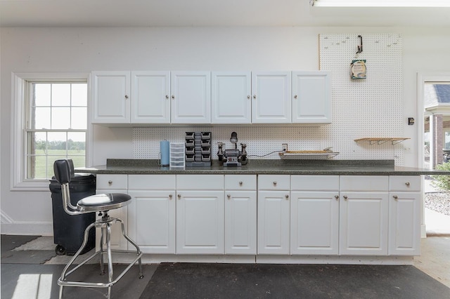 168 Master Ct, Hustonville, KY 40437 - kitchen with dark countertops, white cabinets, and decorative backsplash