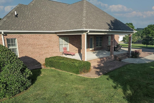 168 Master Ct, Hustonville, KY 40437 - view of side of property with roof with shingles, brick siding, and a lawn