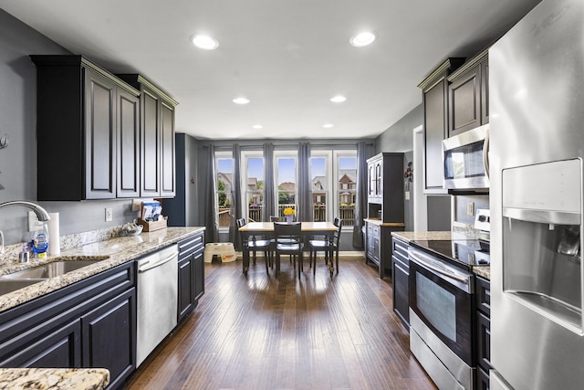 106 Louisa Ln, Georgetown, KY 40324 - kitchen with stainless steel appliances, light stone counters, recessed lighting, and dark wood finished floors