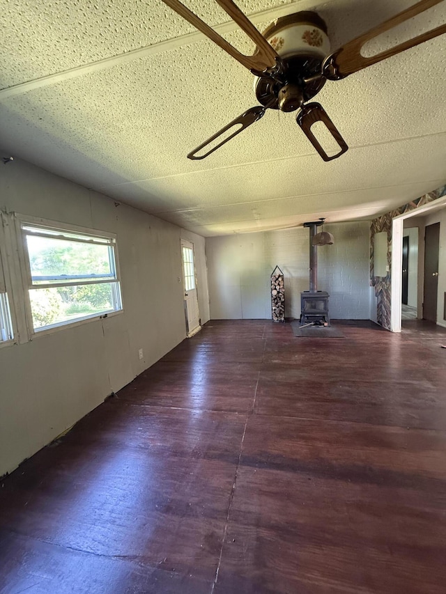 4625 Bardstown Rd, Lawrenceburg, KY 40342 - unfurnished living room featuring a wood stove, ceiling fan, and wood finished floors