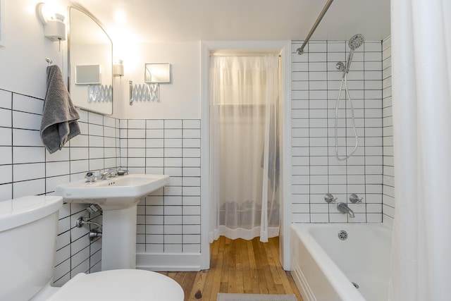 321 Center St, Berea, KY 40403 - full bathroom featuring tile walls, wood finished floors, and shower / bathtub combination with curtain