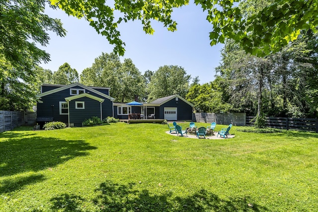 321 Center St, Berea, KY 40403 - fenced backyard featuring a fire pit, a deck, and view of wooded area