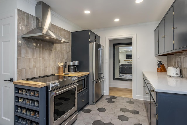 321 Center St, Berea, KY 40403 - kitchen with wall chimney exhaust hood, stainless steel appliances, backsplash, light tile patterned floors, and ornamental molding