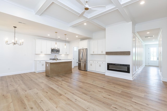 128 Bethany Trce, Lancaster, KY 40444 - kitchen featuring stainless steel appliances, decorative backsplash, open floor plan, beam ceiling, and light countertops