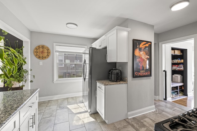 648 Sheridan Dr, Lexington, KY 40503 - kitchen featuring white cabinetry, light stone counters, and stainless steel refrigerator with ice dispenser