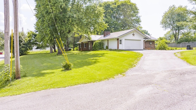 202 Willa Dr, Monticello, KY 42633 - view of front of property featuring a chimney, an attached garage, asphalt driveway, and a metal roof