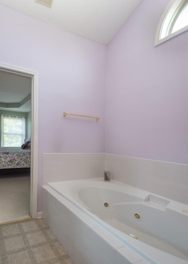 3265 Scottish Trce, Lexington, KY 40509 - ensuite bathroom featuring a jetted tub, healthy amount of natural light, and tile patterned floors
